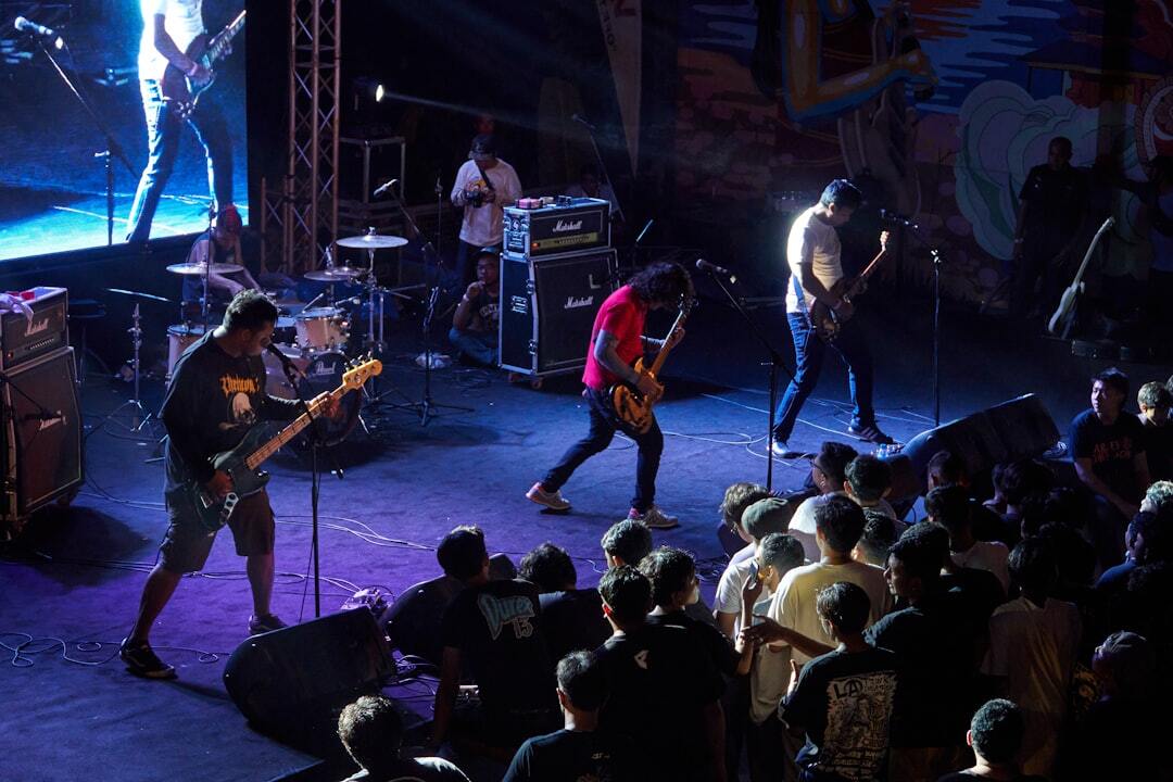 Band on stage under blue lights with the crowd at the rail